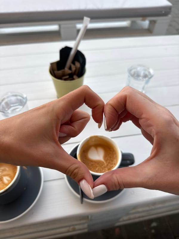 Friends Share Coffee and Selfies at Outdoor Café