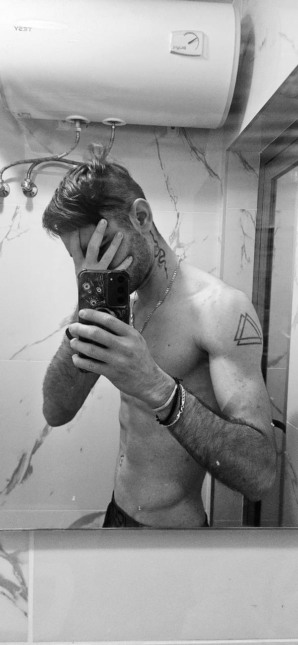 Tattooed person takes bathroom mirror selfies in Plovdiv