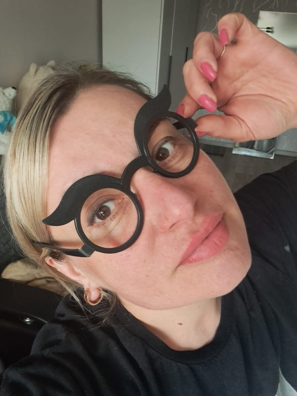 Woman poses with novelty glasses in Elektrostal morning session