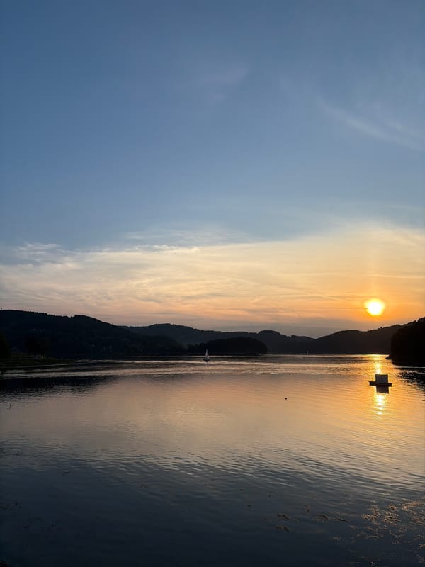 Hot air balloons and a vivid sunset over Lake Rożnowskie