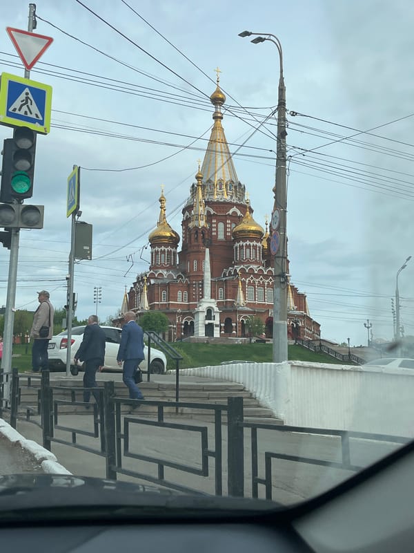 Woman drives past golden-domed cathedral in Izhevsk, Russia