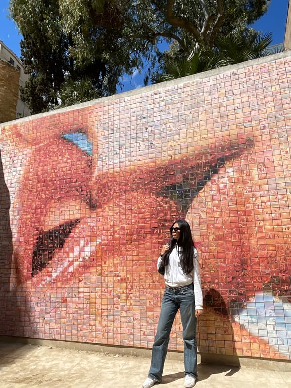 Tourists pose with Barcelona mosaic mural near cathedral