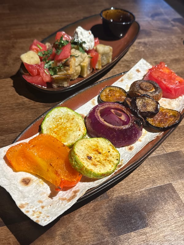 Restaurant spread of grilled vegetables, stews, and salads in Perm
