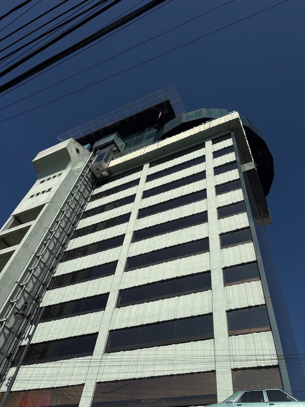 Striped City Express hotel photographed from below in Puebla