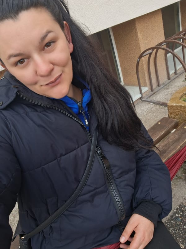 Woman sits on bench in Goce Delcev, Bulgaria