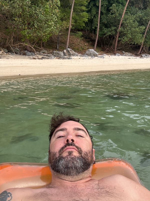 Beachgoers Float on Inflatables at Thai Tropical Beach