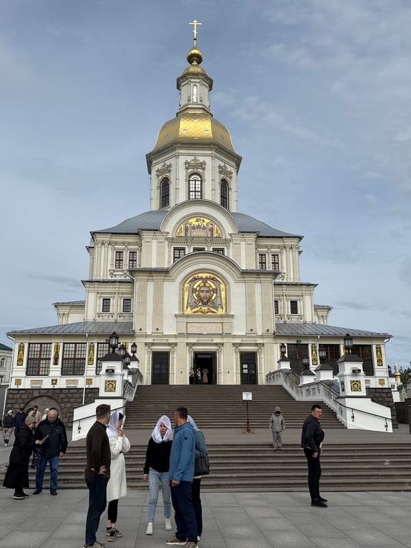 Visitors gather at historic Diveyevo Monastery under cloudy skies