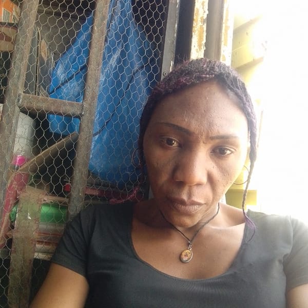 Woman photographed near wire cage in Jos, Nigeria
