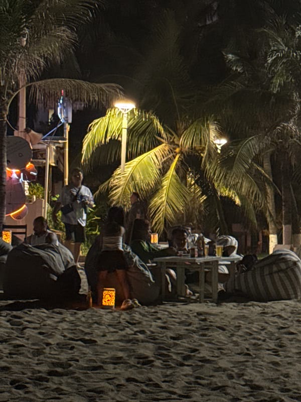 Nighttime beach dining and swimming captured in Nha Trang