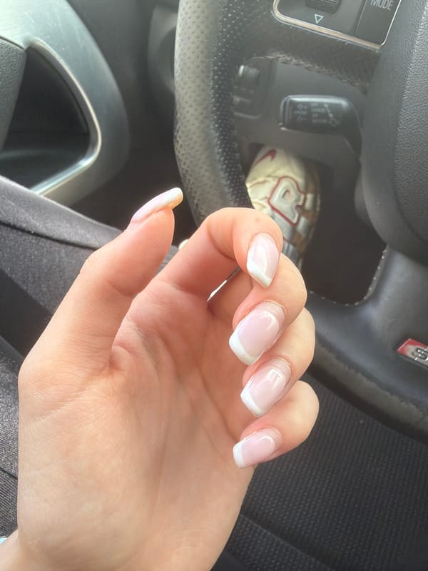 French manicured hand photographed over steering wheel in Smolyan