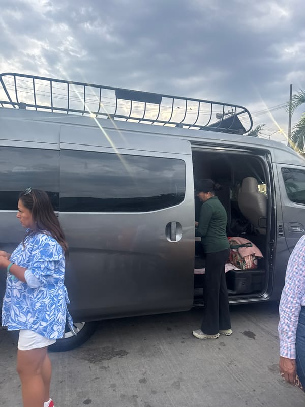 People gather around van in Acapulco midday
