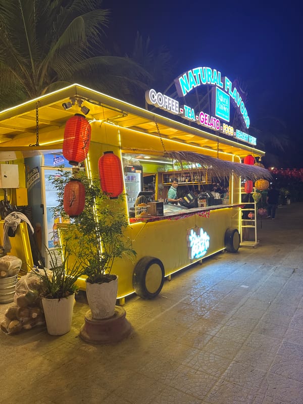 Bright Natural Flavors cafe captured at night in Vietnam