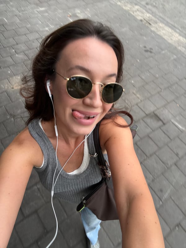 Back-to-back outfit selfies on a Tel Aviv street