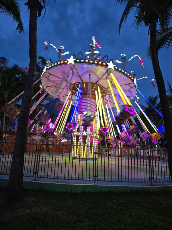Colorful carousel ride glowing at night in Hainan