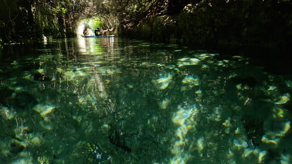 Clear green waters and rocky cliffs of Porto Cesareo