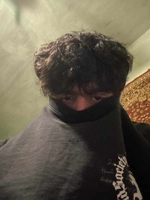 Person in black hooded sweatshirt photographed indoors in Yerevan