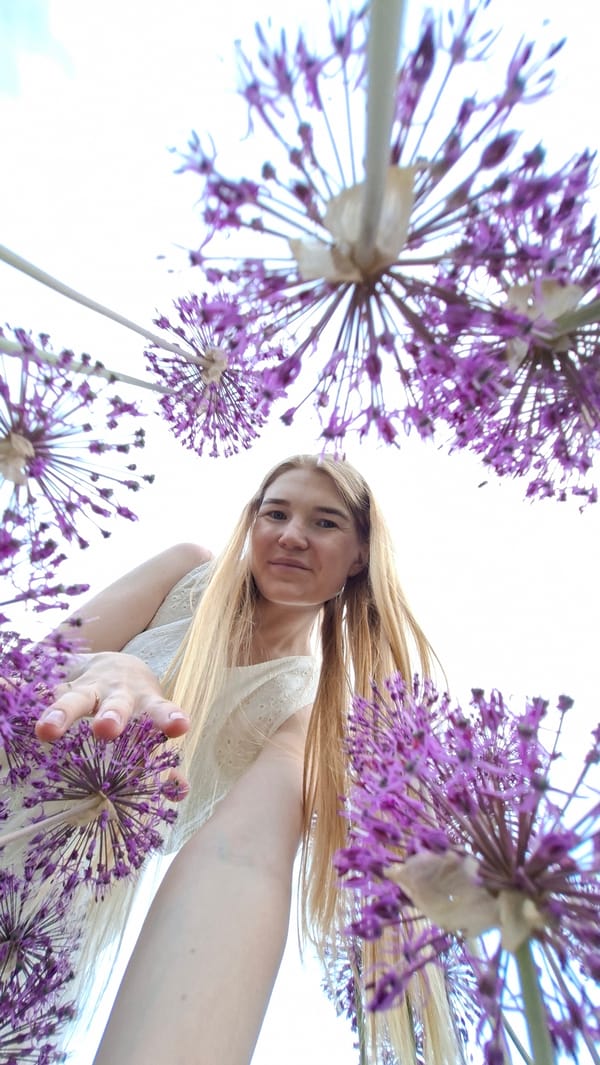 Woman in white dress poses for outdoor photo session in Russia