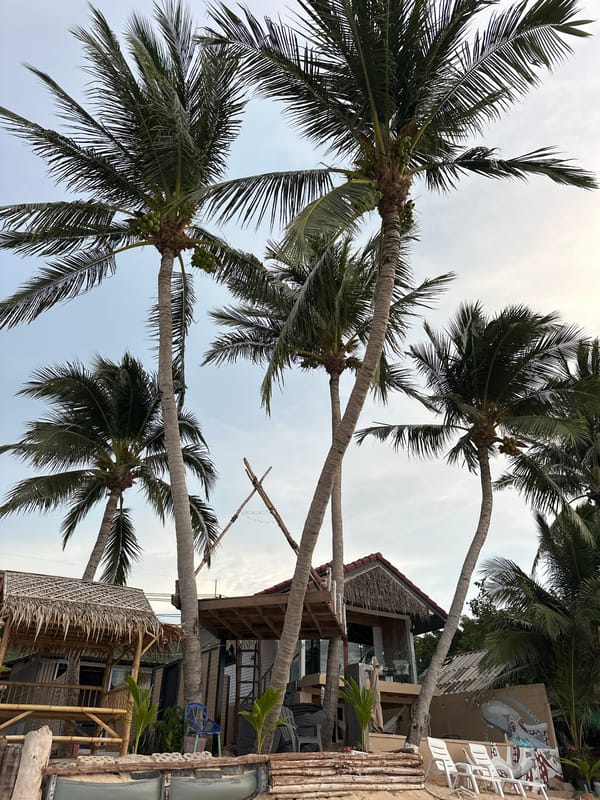Laid-back Ko Samui coastline: beach bars, boats, and cloudy shores