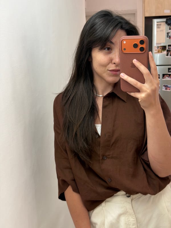 Woman takes indoor selfie with iPhone in Givatayim