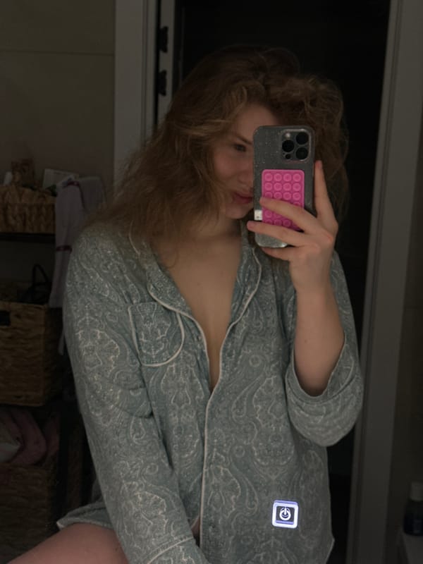 Woman takes mirror selfie in patterned pajamas in Kazan