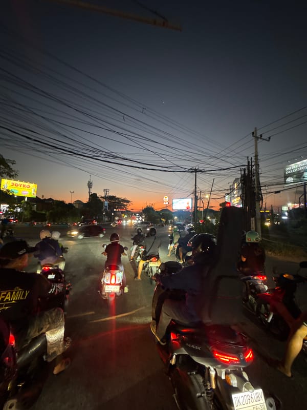 Kuta evening traffic under a vivid sunset sky