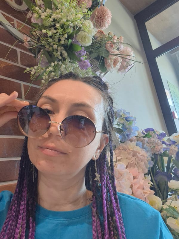 Woman poses for photos at flower-filled cafe in Votkinsk