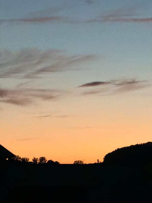 Sunset over Junglinster countryside creates dramatic twilight display