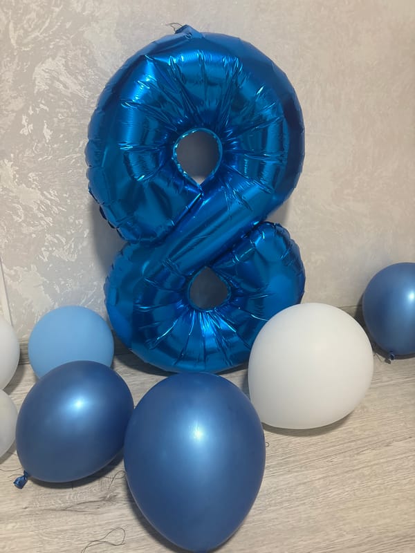 Birthday balloons, a twilight street view, and a globe in Krasnoyarsk