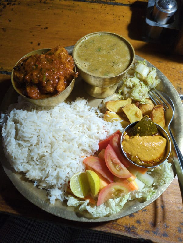 Thali lunch and rainy streets in Bhagsu, India