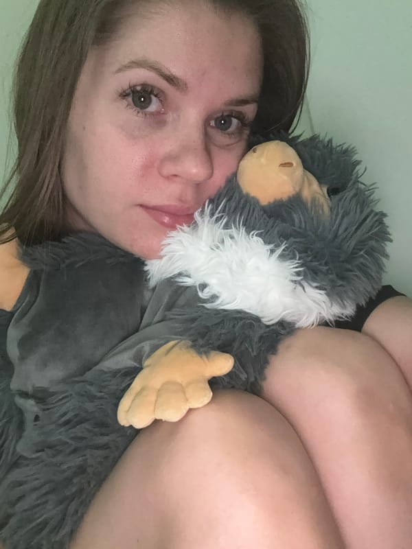 Woman poses with plush toy in casual indoor photos