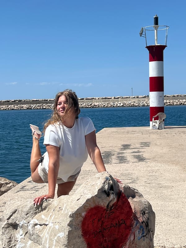 Woman photographed posing at sunny coastal pier in Bar, Montenegro