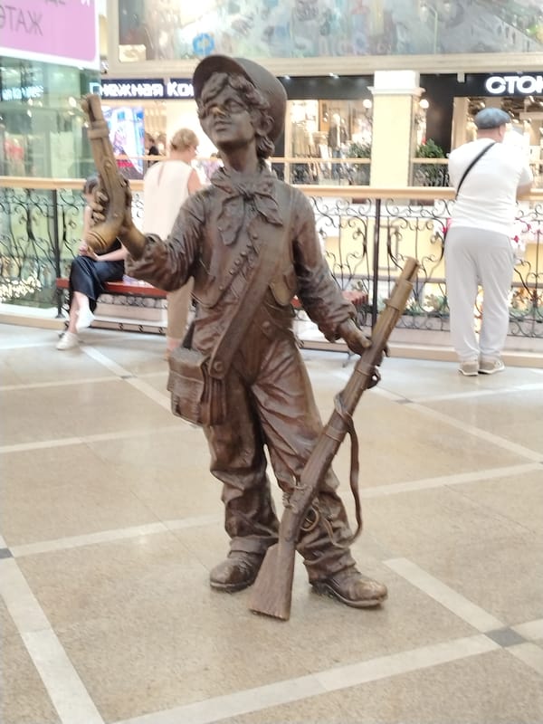 Public statues and a shopping mall interior, one morning