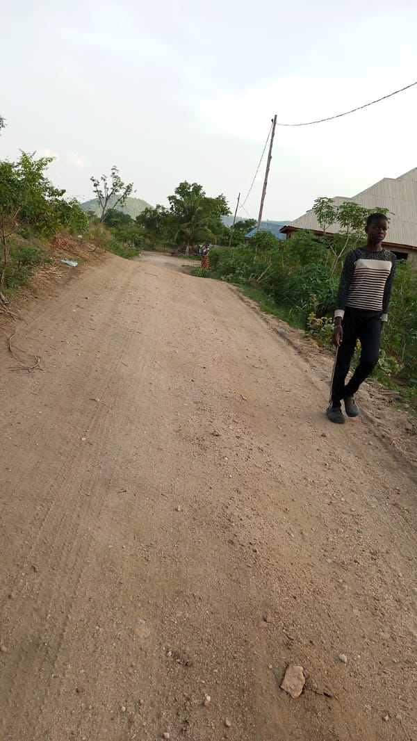 Two women walk dirt road in Adankolo, Nigeria