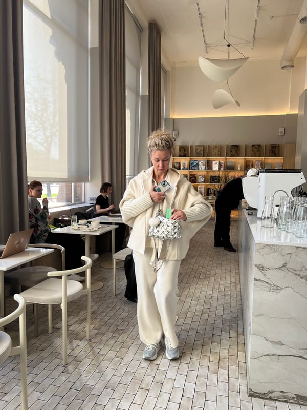 Woman enjoys coffee at Minsk café during spring afternoon