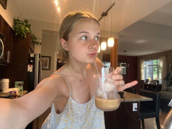 Woman enjoys iced drink in Whistler, Canada