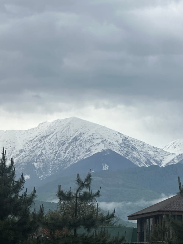 Overcast skies blanket snow-dusted mountains in Krasnaya Polyana