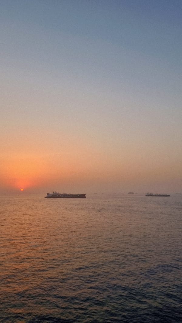 Ships anchored at dusk in calm waters