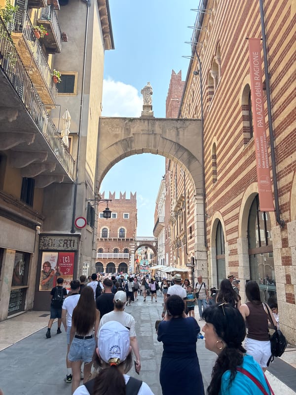 Tourist documents morning walk through historic Verona's crowded streets
