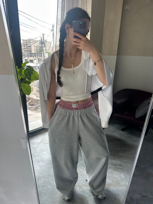 Person takes mirror selfies in white hoodie in Zovuni