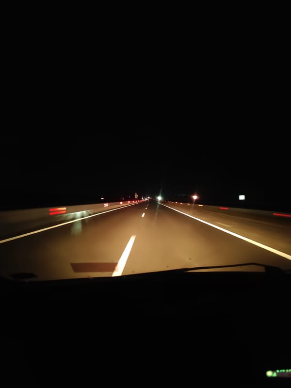 Late-night highway drive through wet roads in rural Bulgaria