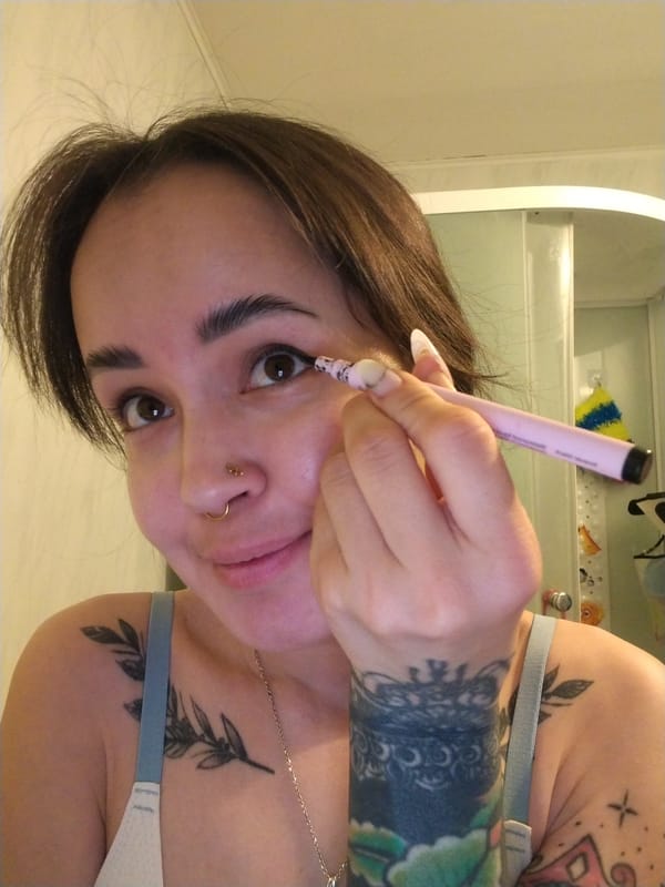Woman applies makeup during early morning routine