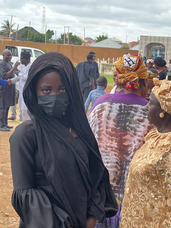 Community gathering with drumming and traditional dress in Jos, Nigeria
