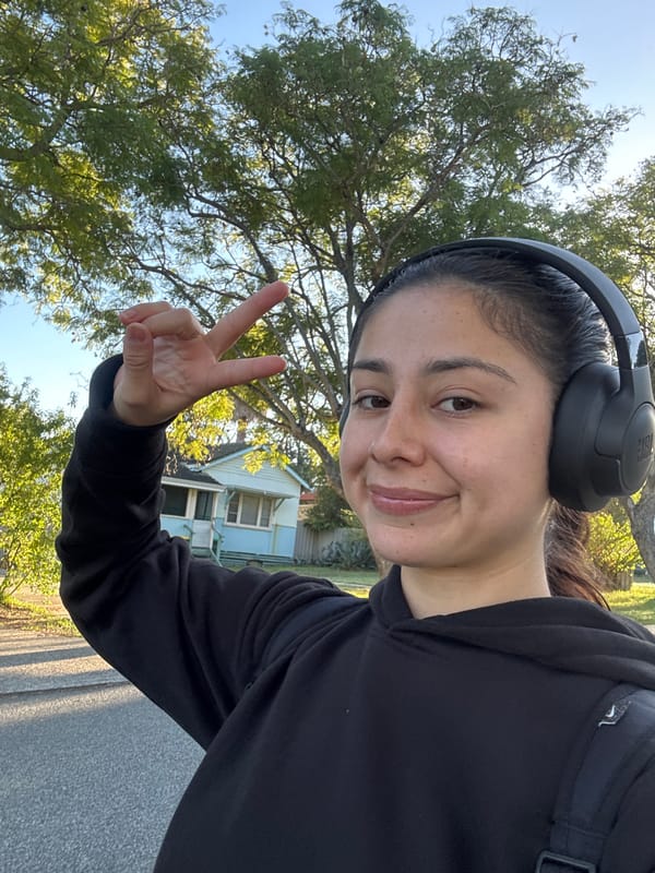 Person takes nighttime selfie with peace sign in Calista