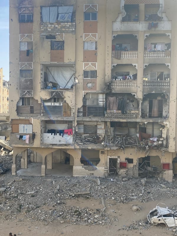 Damaged buildings and people documented in Khan Yunis