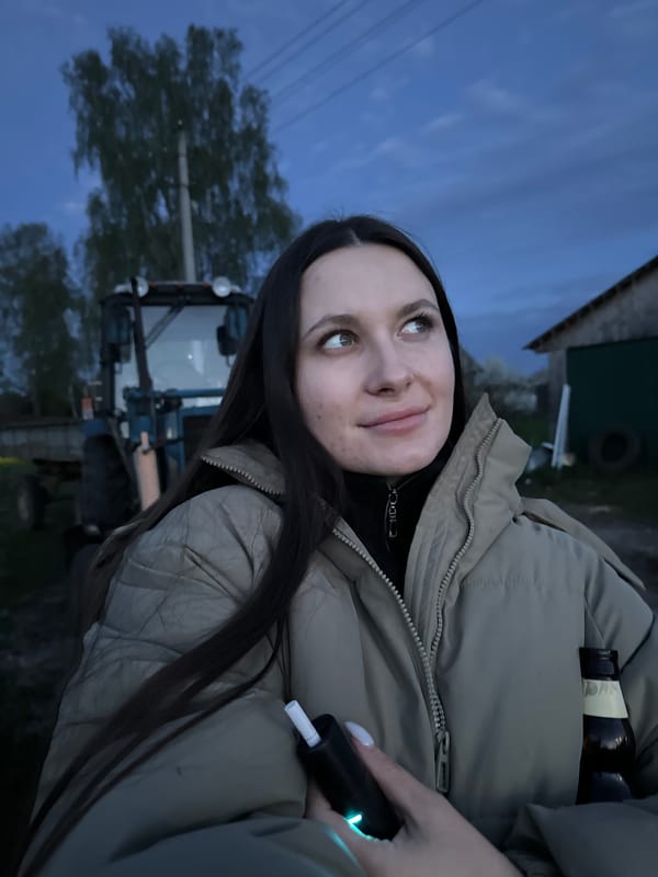 Family gathers around tractor at dusk in rural Russia