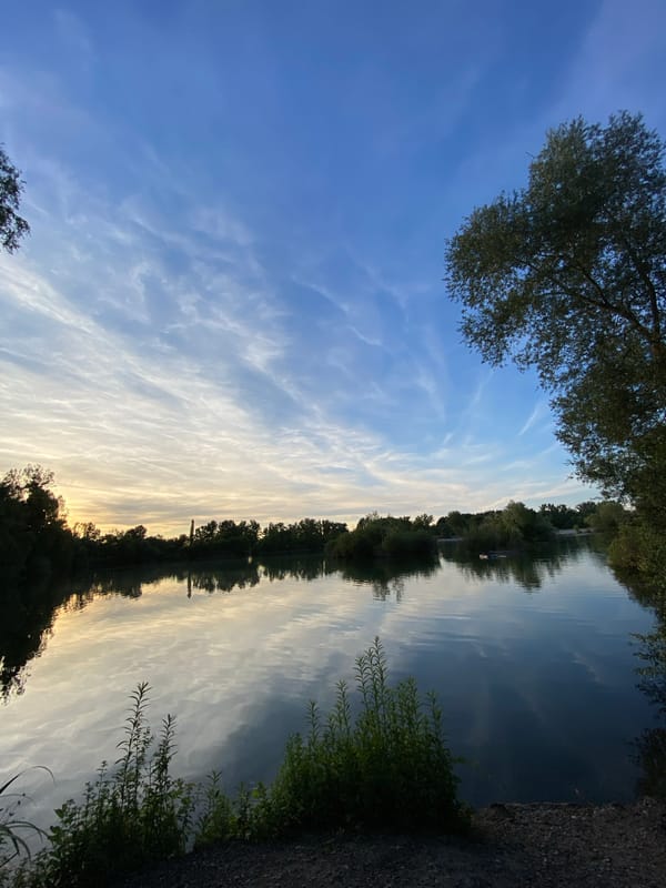 Sunset over a calm lake in Hœnheim, France