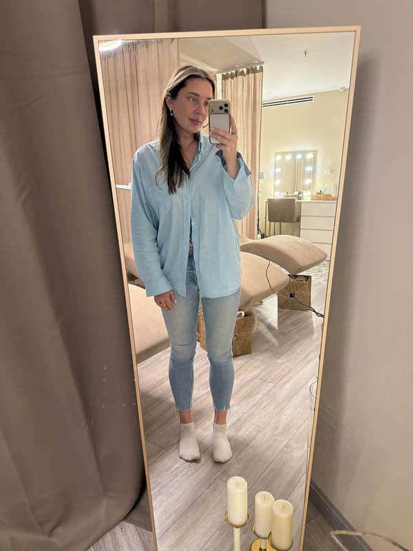 Woman Takes Mirror Selfie in Beige Room in Dolgoprudny