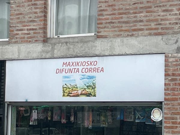 Man sweeps sidewalk near Buenos Aires convenience store