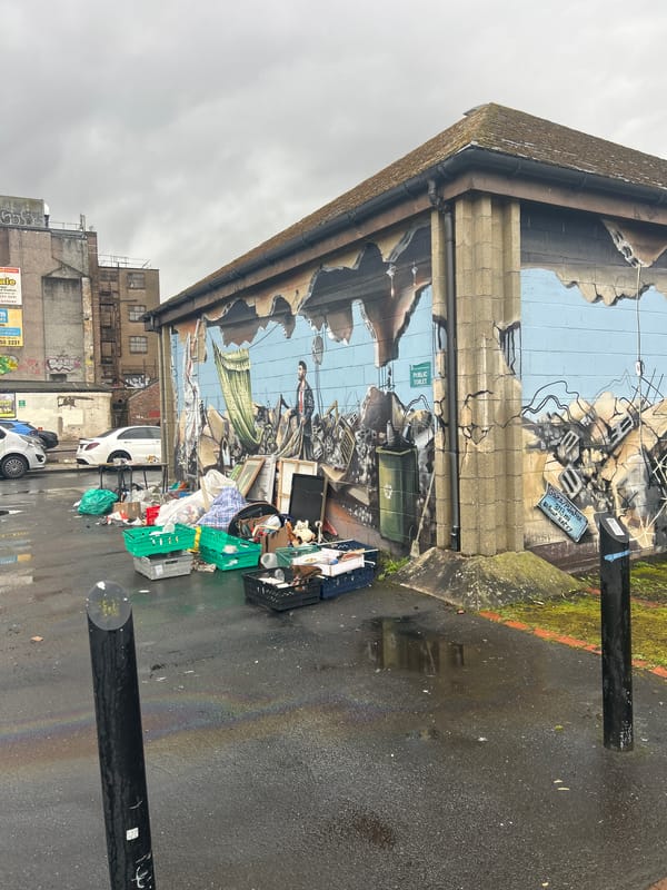 Street art documented in Glasgow including war mural, woman stencil
