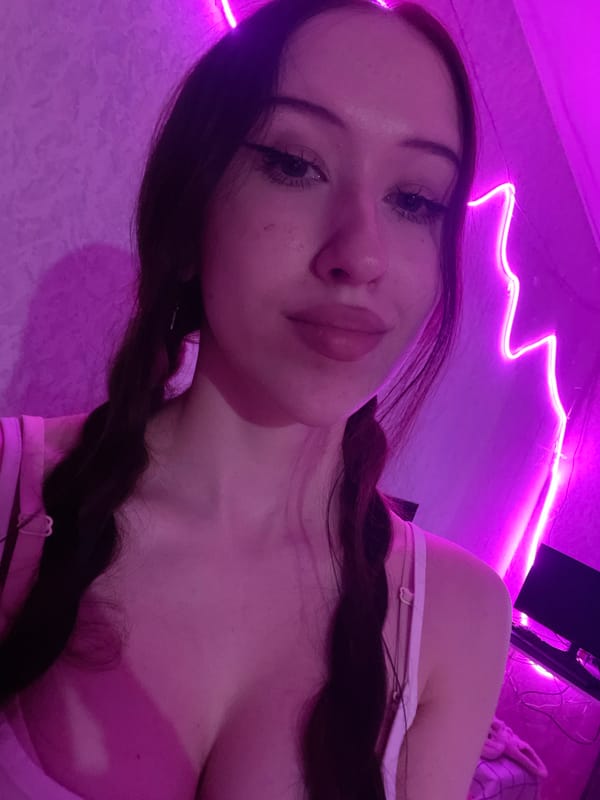 Woman takes selfies in purple-lit room in Votkinsk, Russia